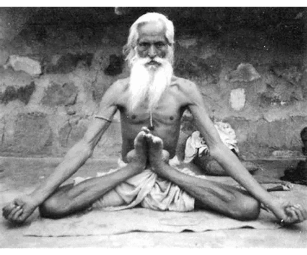 Elderly Indian yogi seated in Padmasana with hands resting on knees