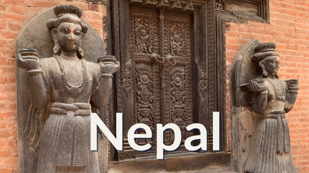 Stone guardian statues flanking an intricately carved wooden temple door in Bhaktapur, Nepal