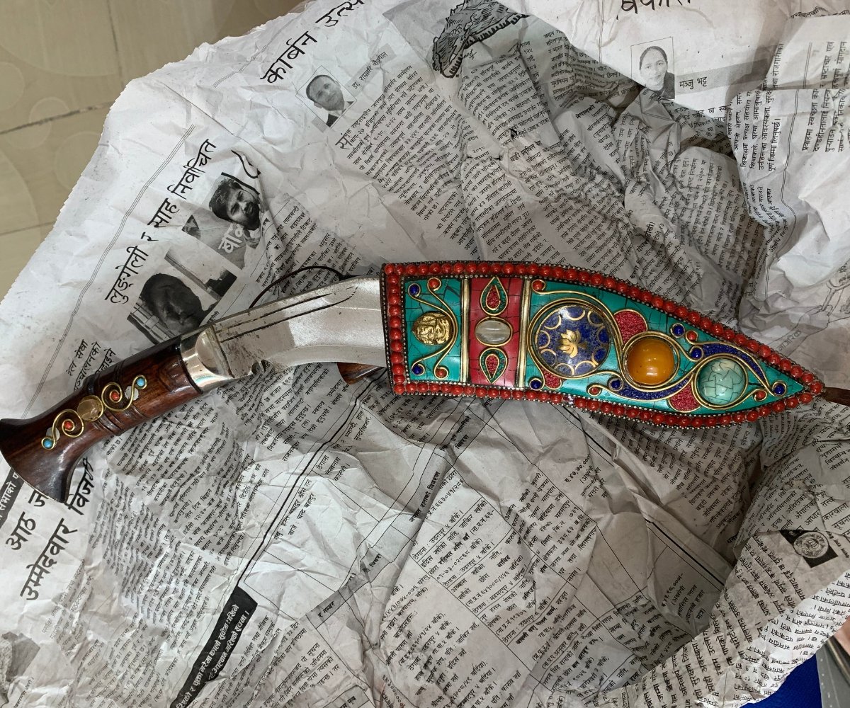 Handcrafted Nepali kukri knife with ornate gemstone-inlaid sheath and wooden handle