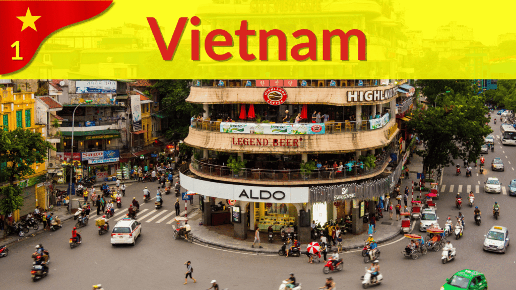 Busy Hanoi intersection filled with scooters, taxis, and pedestrians