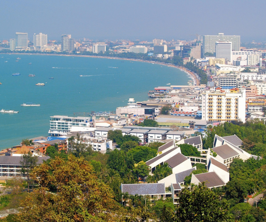 Coastal skyline of Pattaya with beachfront buildings and boats in the water