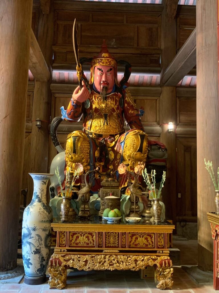 Brightly painted guardian statue inside a traditional Vietnamese temple.