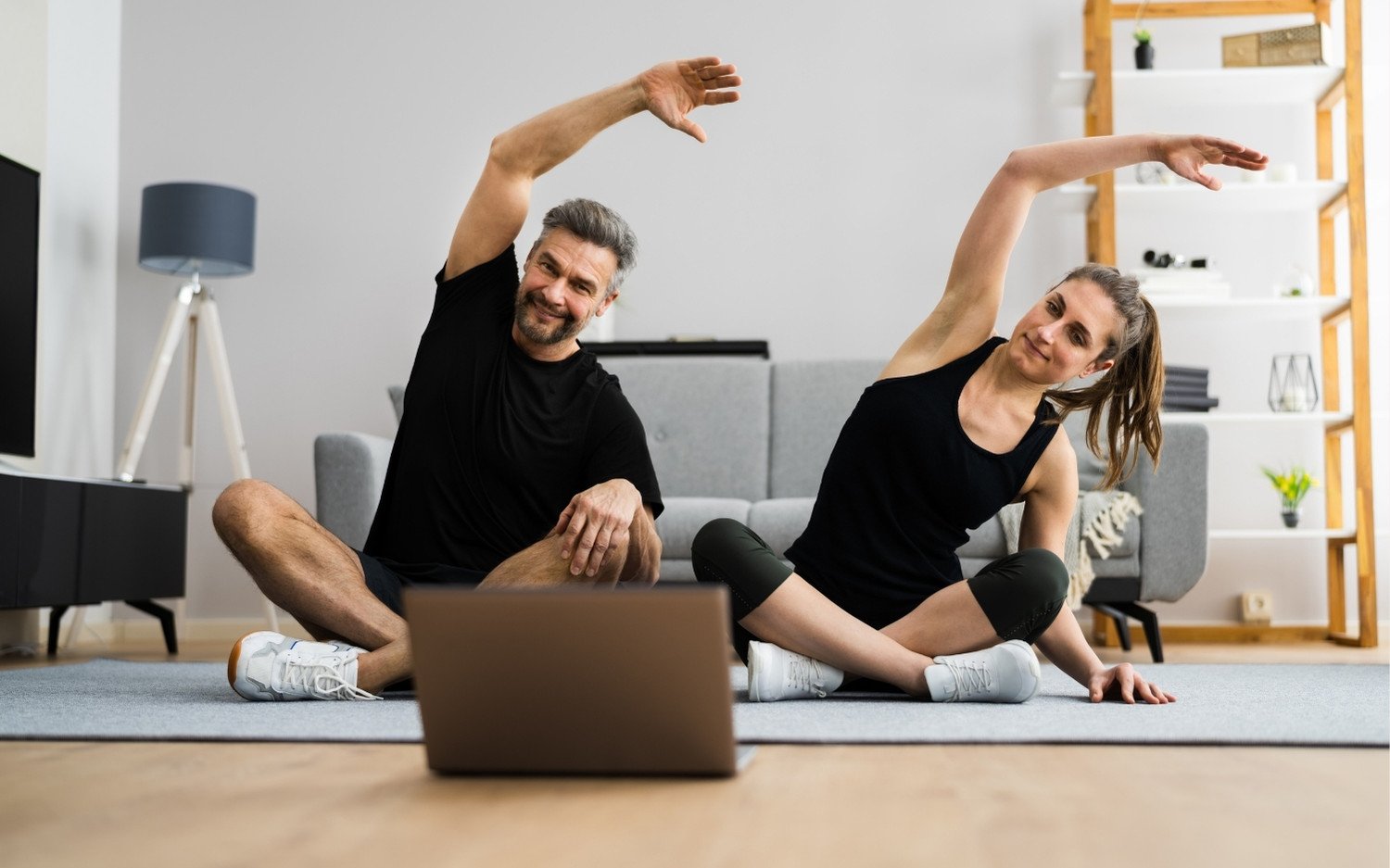 continuing-education-yoga-teachers-online-class Couple taking part in continuing education for yoga teachers through an online yoga class
