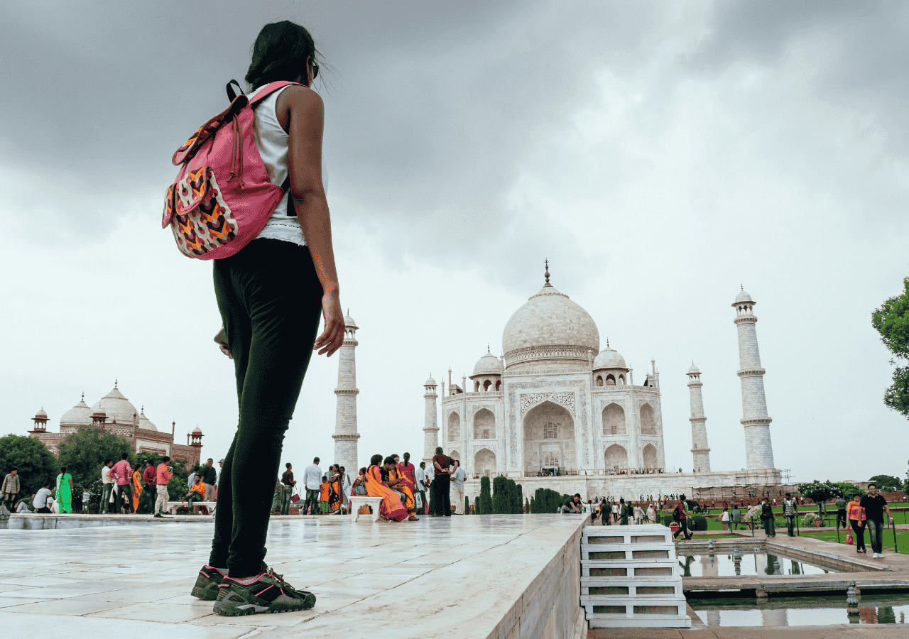 womens-safety-india-solo-traveler-taj Solo female traveler with backpack at the Taj Mahal, symbolizing women’s safety and travel in India