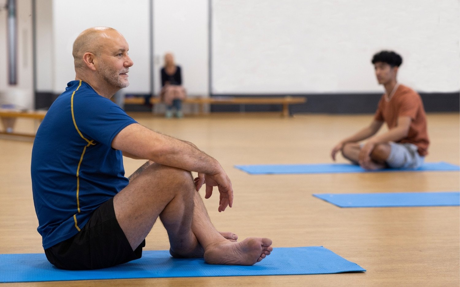 yoga-teacher-trainee-seated Yoga teacher trainee practicing a seated twist during class