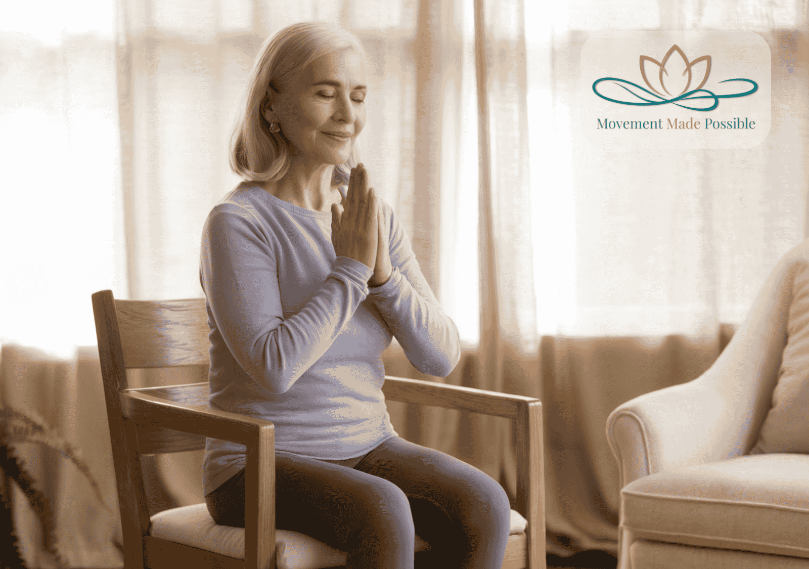 Older woman sitting on a chair with eyes closed and hands together in prayer position