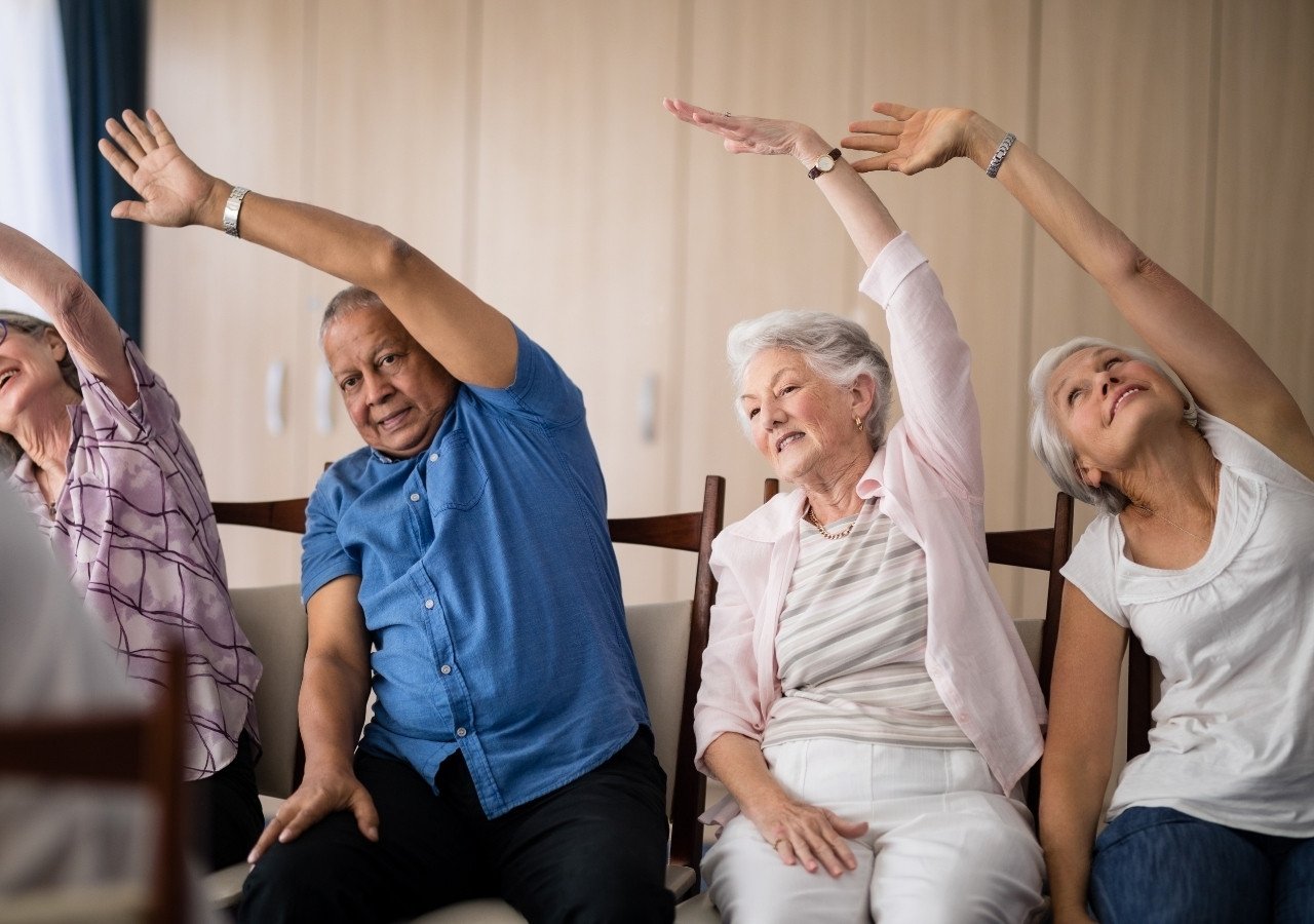 Group of seniors  doing chair yoga