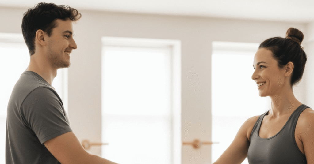 Yoga teacher greeting a student with a handshake before a private session.